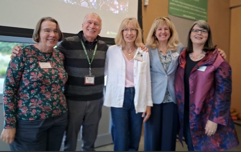 Photo of Cleo Raulerson smiling by hydrangeas